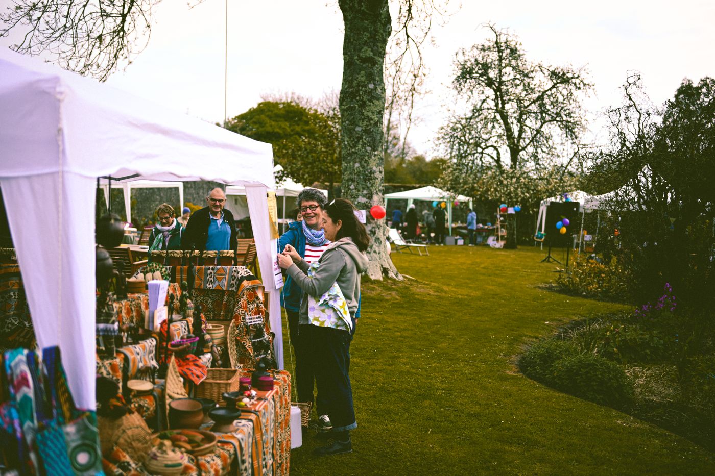 Gazebo stalls at an outdoor community event in a park